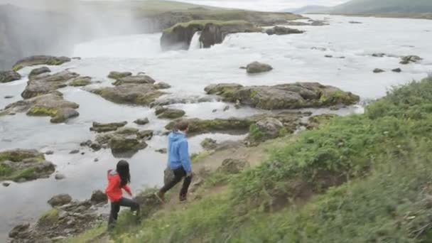 Caminhadas casal em caminhada pela Islândia cachoeira — Vídeo de Stock