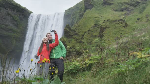 Pareja tomando foto de la cascada — Vídeo de stock