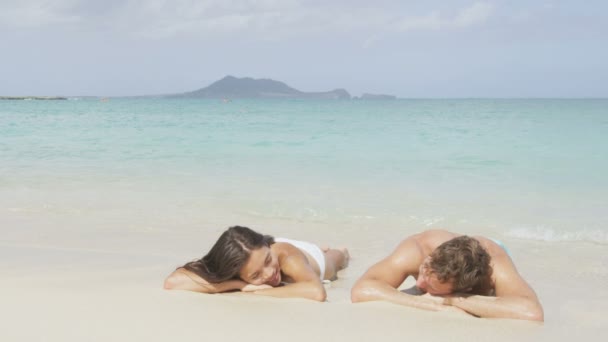 Suntan couple relaxing in water and sand — Stock Video