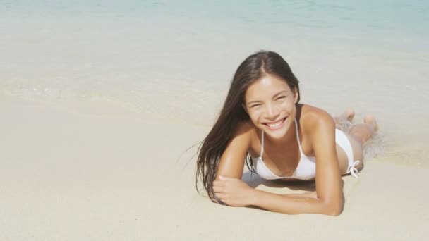 Fille couchée sur la plage sable dans l'eau — Video