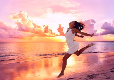 woman running on the beach at sunset clipart