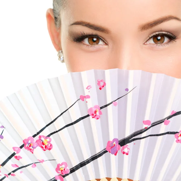 Young woman with folding fan — Stok fotoğraf