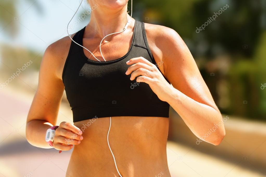 Jogger running in sports bra Stock Photo by ©Maridav 97352440