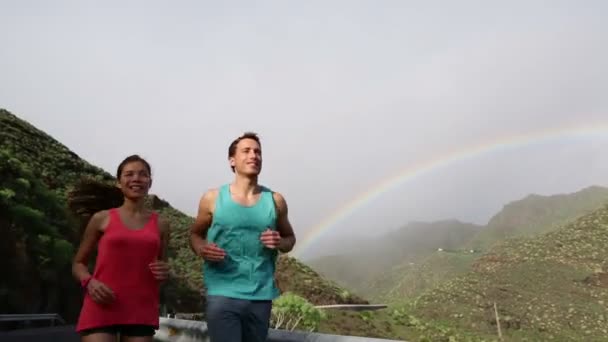 Male and female joggers against mountains — Stock Video