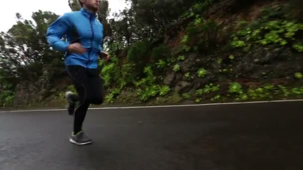 Young man running on road — Stock Video