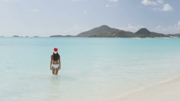 Woman in Christmas Santa hat on beach — Αρχείο Βίντεο