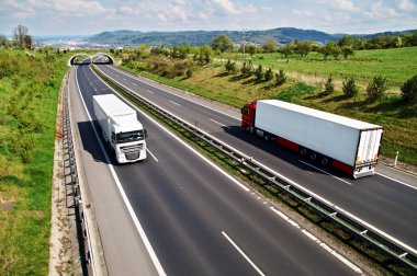 Corridor highway with the transition for animals, going down the highway two trucks clipart