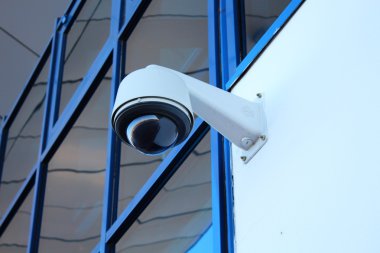 Outdoors surveillance camera on the white wall clipart