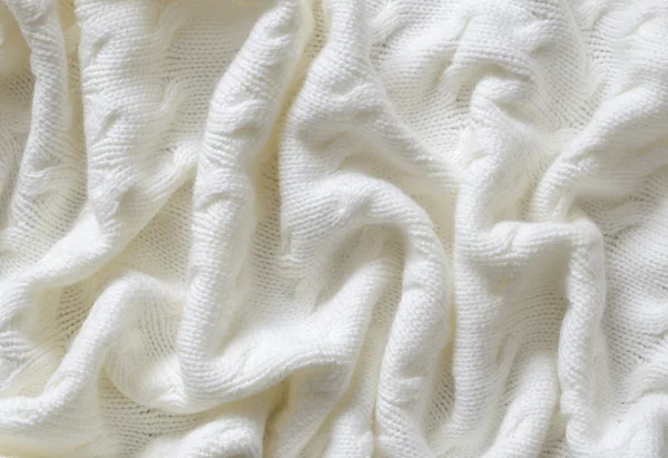 Crumpled white knitted blanket — Stock Photo, Image