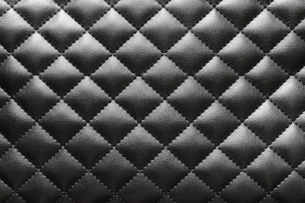 Texture of black quilted artificial leather — Stock Photo, Image