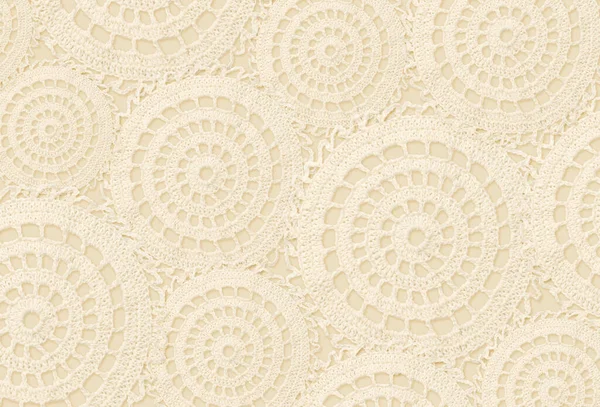 Craft background with beige crochet circles. Top view. Flat lay.