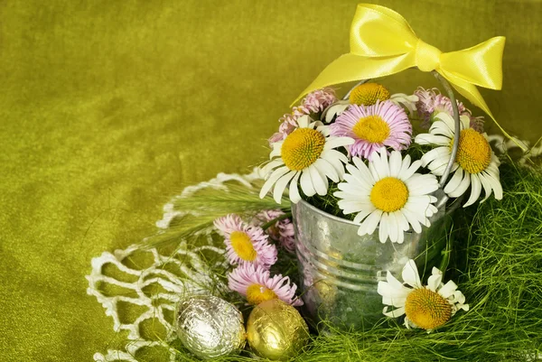 Buquê de margaridas em um balde de metal e ovos de shocolate — Fotografia de Stock