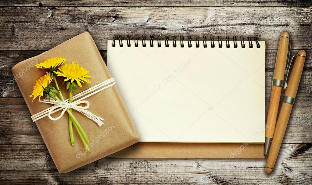 Gift and note on dark wooden background