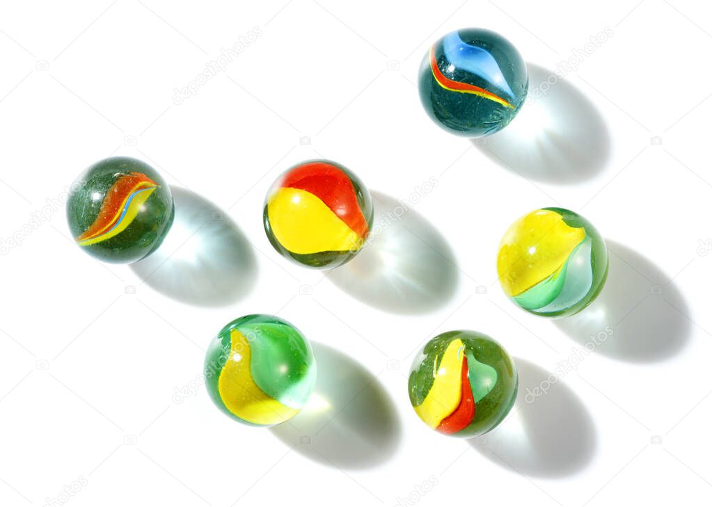 colorful galss marbles to play on white background
