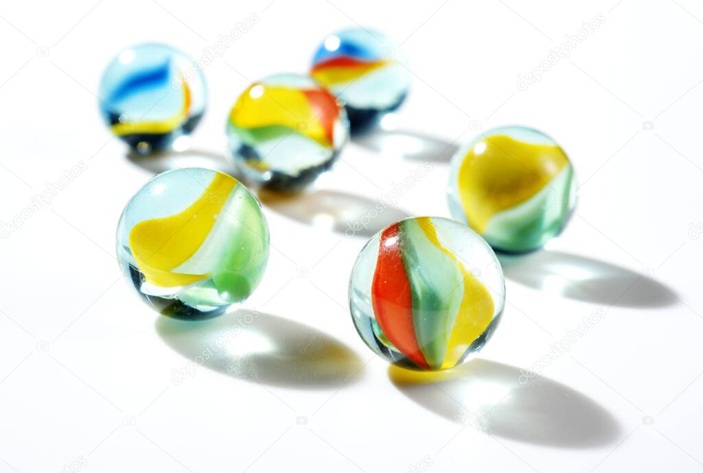 colorful galss marbles to play on white background