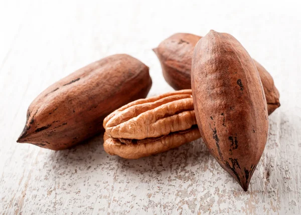 Pecan nuts on white wood — Stock Photo, Image