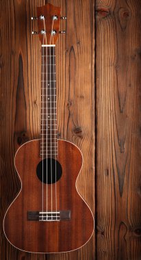 ukulele on wooden background clipart