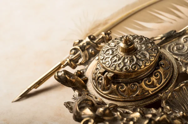 Antique inkstand on old parchment — Stock Photo, Image