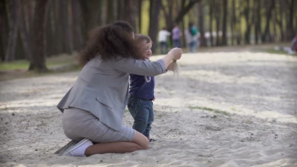 Moeder met kinderen spelen met zand — Stockvideo