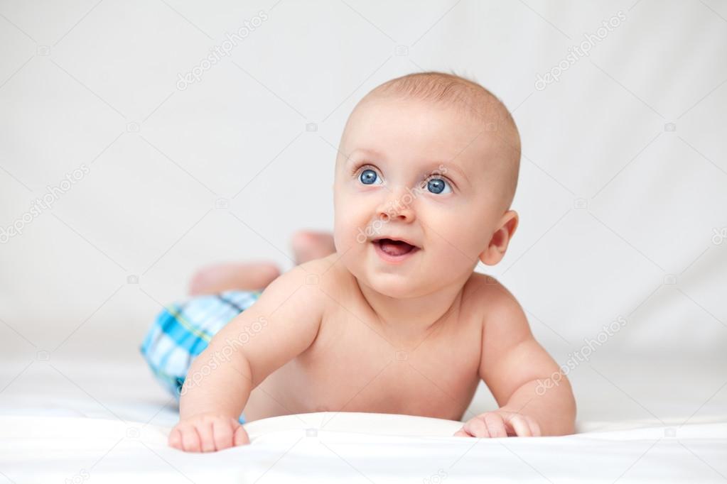 Portrait of a baby on the bed in her room