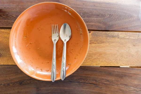 Empty dish after food on wooden table — Stock Photo, Image