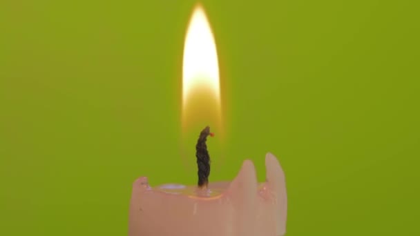 Primer plano soplar la vela ardiente aislado sobre fondo amarillo — Vídeo de stock