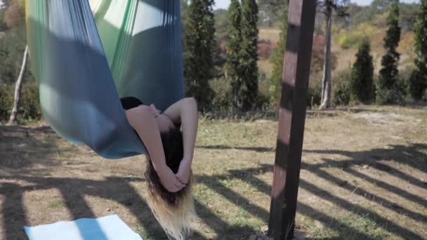 Jeune femme ment et balance dans l'hamac dans la nature. concept d'harmonie du corps et de l'état d'esprit — Video