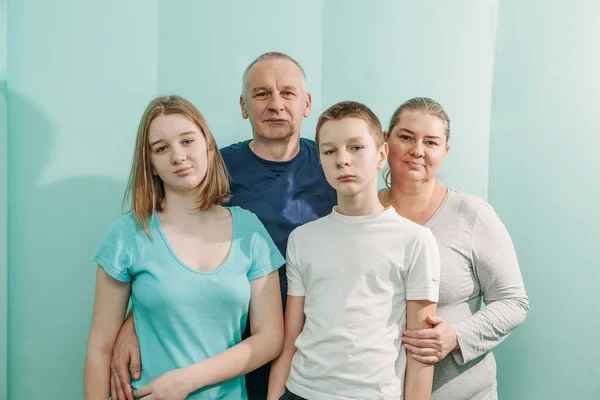 doctor with happy family of mother father son and daughter at the hospital medical healthcare