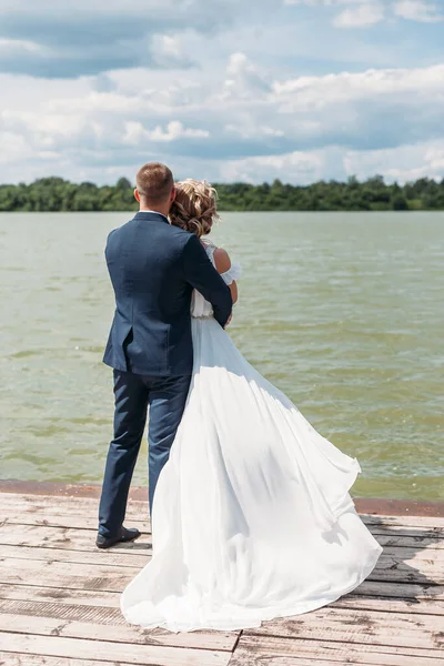 Groom Hugs Bride Tender While Enjoy Wind Lake — Stock Photo, Image