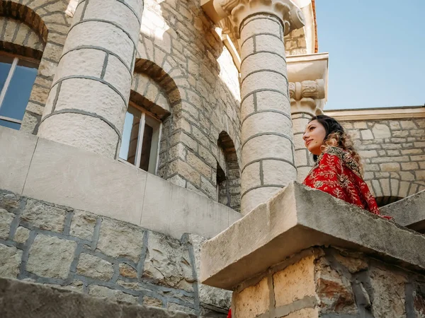 Beautiful ethnic Indian Saree. Young woman in red, colorful, sensual, wedding and very feminine outfit - Indian sari poses on old streets in India.