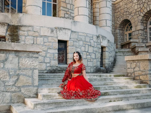 Beautiful ethnic Indian Saree. Young woman in red, colorful, sensual, wedding and very feminine outfit - Indian sari poses on old streets in India.