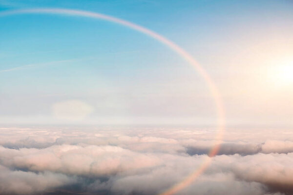 bird eye view at clouds at sunset in blue sky top view from drone from airplane window