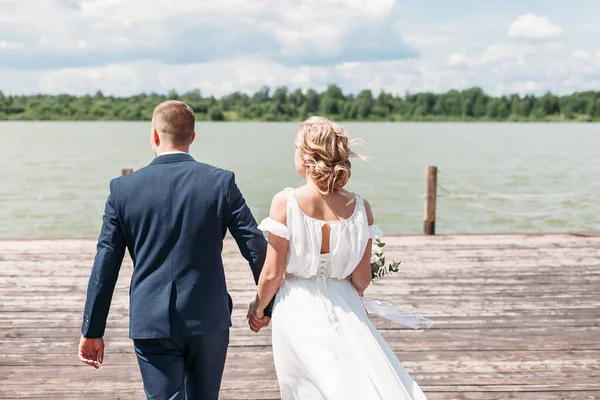 Bride Groom Walk Wooden Pier Lake Summer Holding Hands Backs — Stock Photo, Image