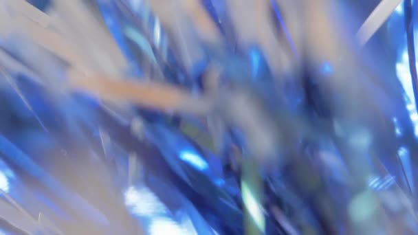 Abstract holiday background, close-up. shiny christmas blue tinsel. blur, selective focus. copy space. — Stock Video