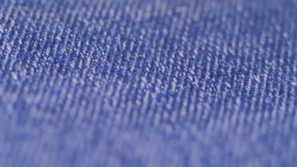 Super close-up of blue denim fabrics details. texture of textiles. concept of sewing workshop. 4k video — Stock Video