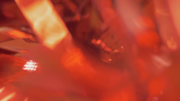 Abstract holiday background, close-up. shiny christmas red tinsel. blur, selective focus. copy space — Stock Video