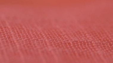 Pembe kumaş ayrıntıları. Tekstil dokusu arka plan olarak kullanılıyor. Dikiş atölyesi konsepti. 4K 'lık yakın çekim videosu. Görüntü, seçici odaklanma. kaydırıcı