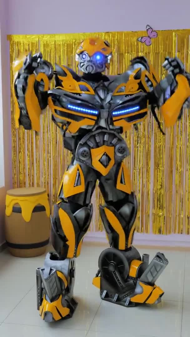 Vidéo verticale. Un animateur en costume de robot bourdon transformateur jaune modèle danse. L'homme en costume fait des mouvements robotiques créatifs. Russie, Stavropol, 27.04.21 — Video