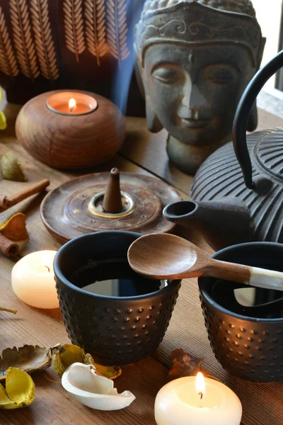 Cups of black tea accompanied by incense — Stock Photo, Image