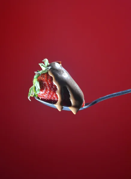 Strawberry falling a little chocolate liquid — Stock Photo, Image