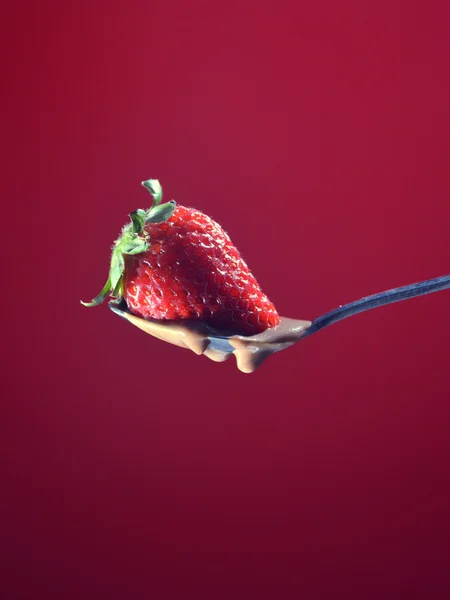 Strawberry falling a little chocolate liquid — Stock Photo, Image