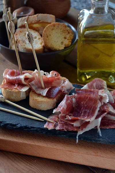 Appetizer of ham Serrano with bread roasted — Stock Photo, Image