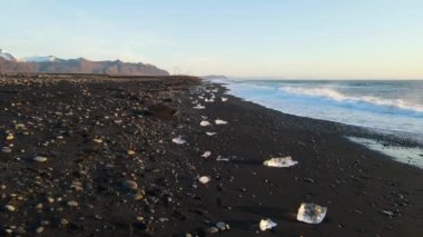 Güney İzlanda 'daki Glacier Lagoon Jokulsarlon' daki Diamond Beach 'in yüksek kaliteli hava görüntüleri. Küçük buzdağları olan terk edilmiş siyah kumsal.