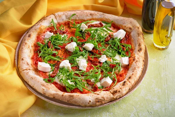 Healthy quinoa pizza with tomatoes and sun dried tomatoes and goats cheese