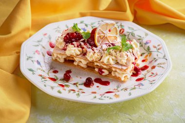 Millefeuille with berries on light stone background. menu