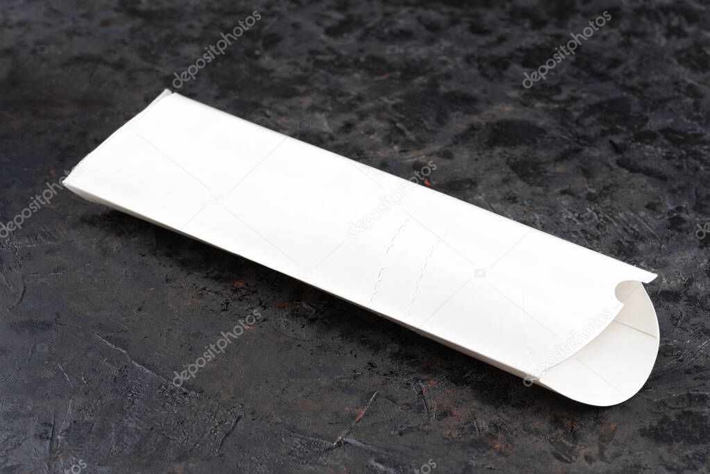 Top view of white blank doner kebab paper packaging. dark stone surface. Ideal for advertisement. Close-up for menu