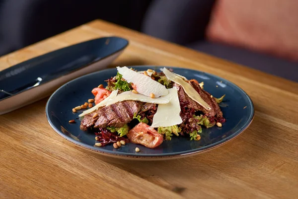 Теплий салат з телятиною на грилі, помідорами, баклажаном на столі в ресторані — стокове фото