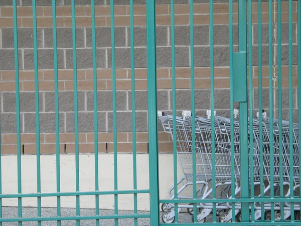 Grocery Cart Line Behind Fence — Stock Photo, Image