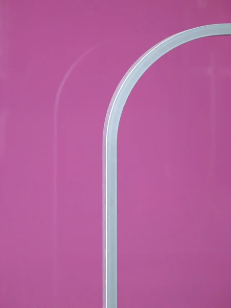 Стальные рельсы и розовая стена — стоковое фото