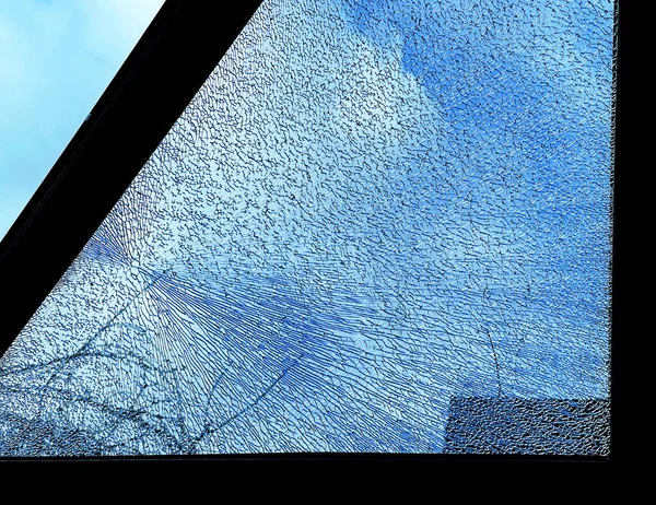 Shattered pane of toughened glass in the roof of a conservatory. No people.